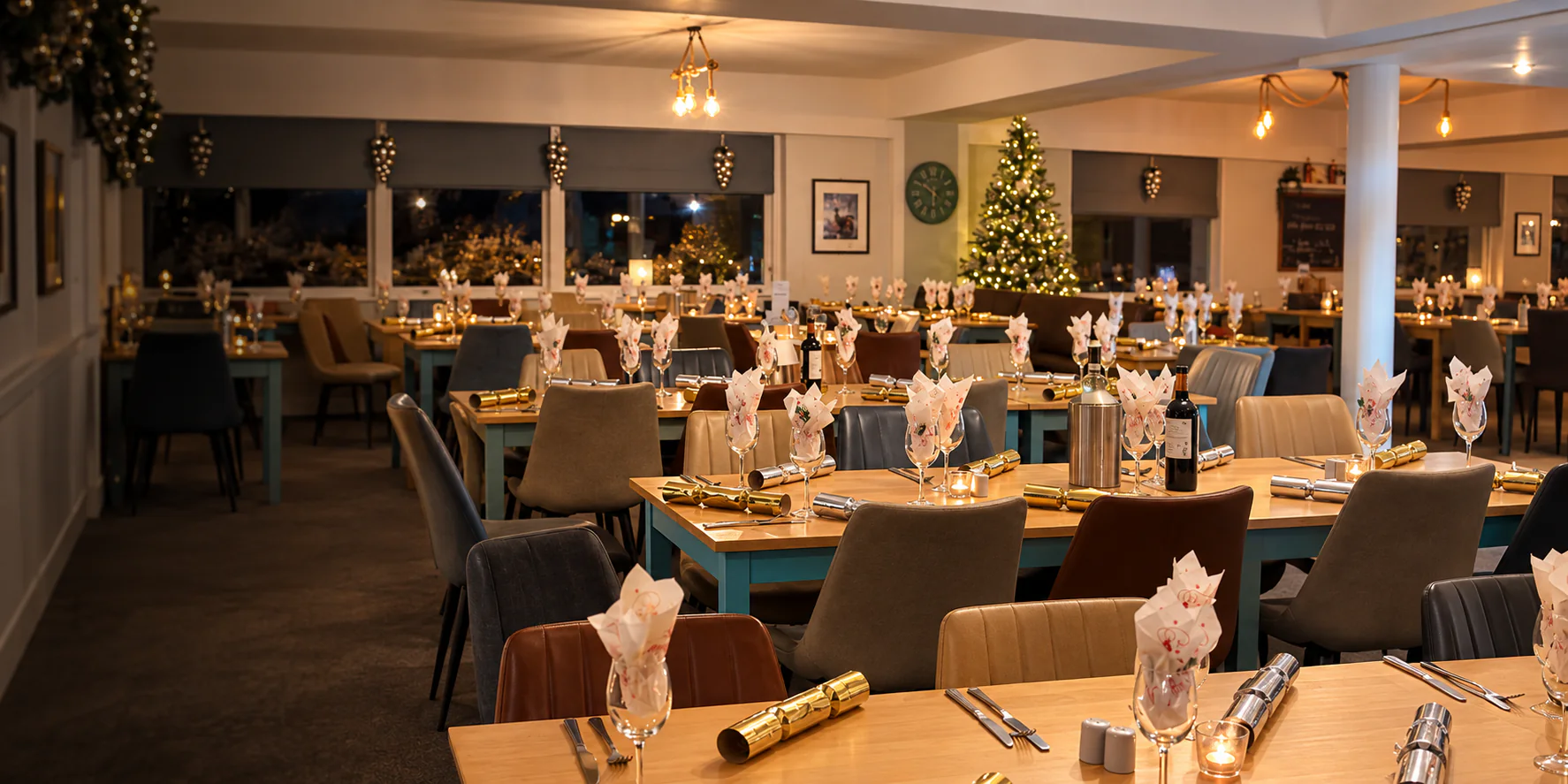 The Seashells dining room dressed for Christmas with festive tables and an illuminated tree